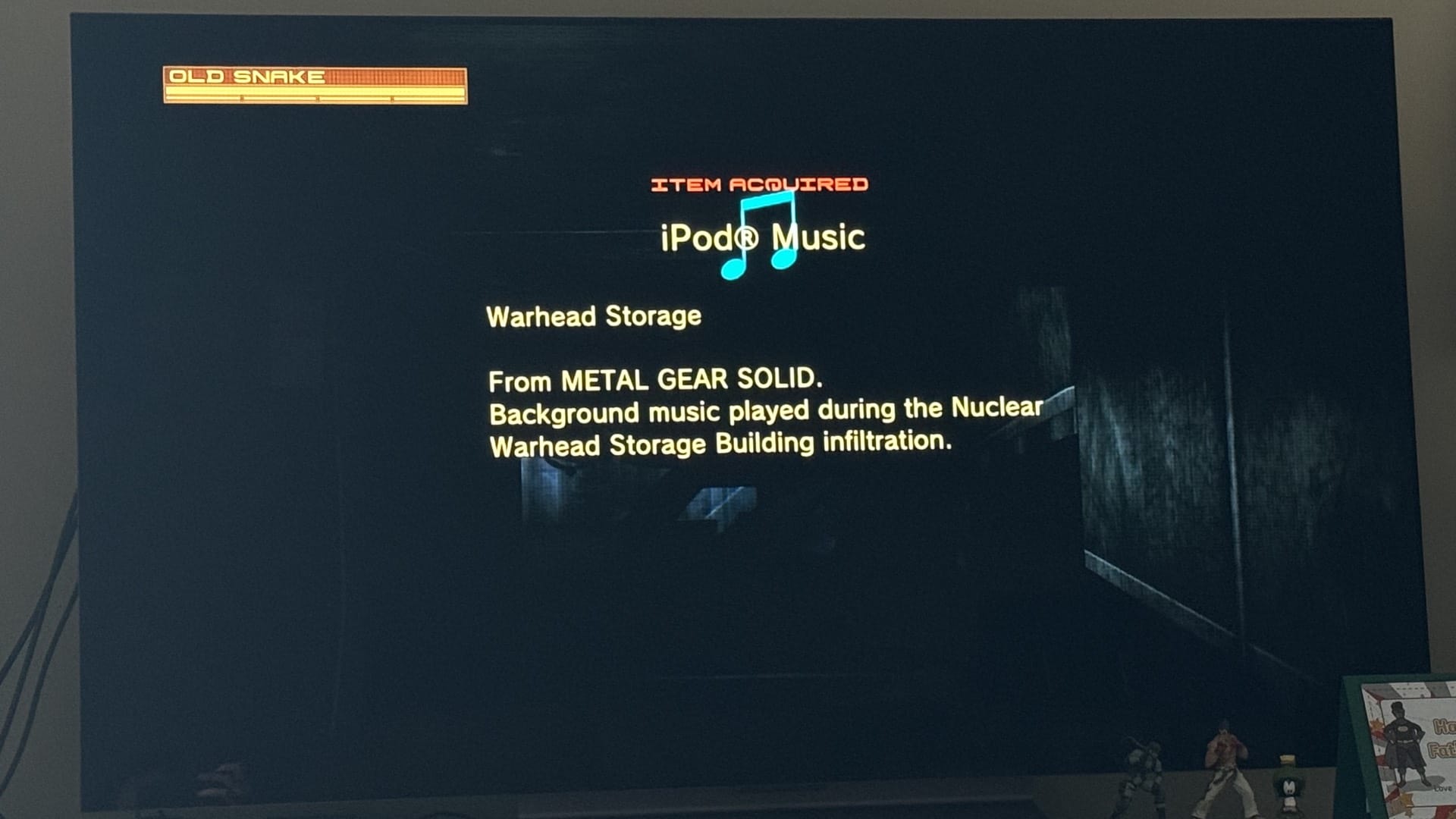 MGS4 item-acquired screen showing iPod Music unlocked: the 'Warhead Storage' track from the original Metal Gear Solid